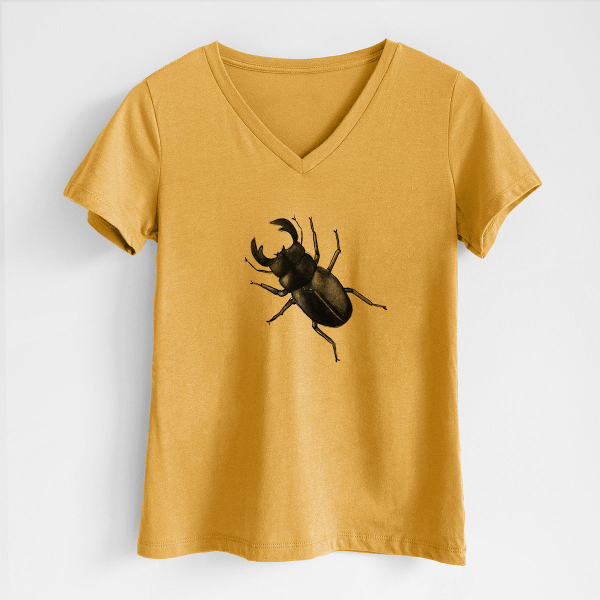 Honeycomb yellow women's relaxed fit cotton V-neck t-shirt laid flat, printed with a detailed black ink illustration of a giant stag beetle with large jaws, seen from above.