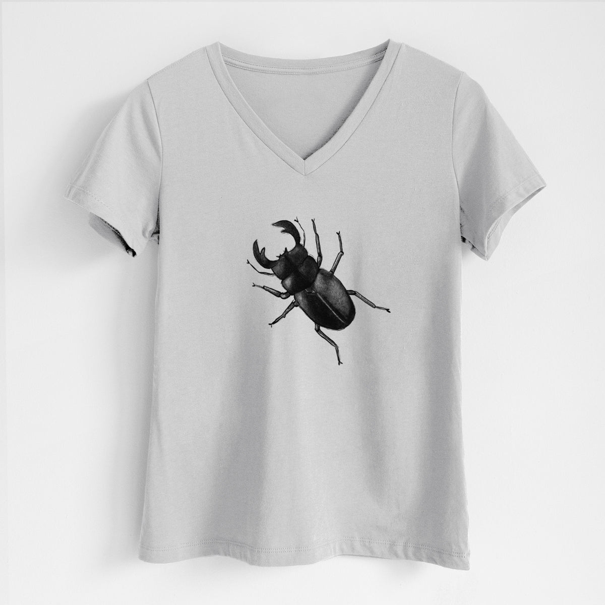 Lunar grey women's relaxed fit cotton V-neck t-shirt laid flat, printed with a detailed black ink illustration of a giant stag beetle with large jaws, seen from above.