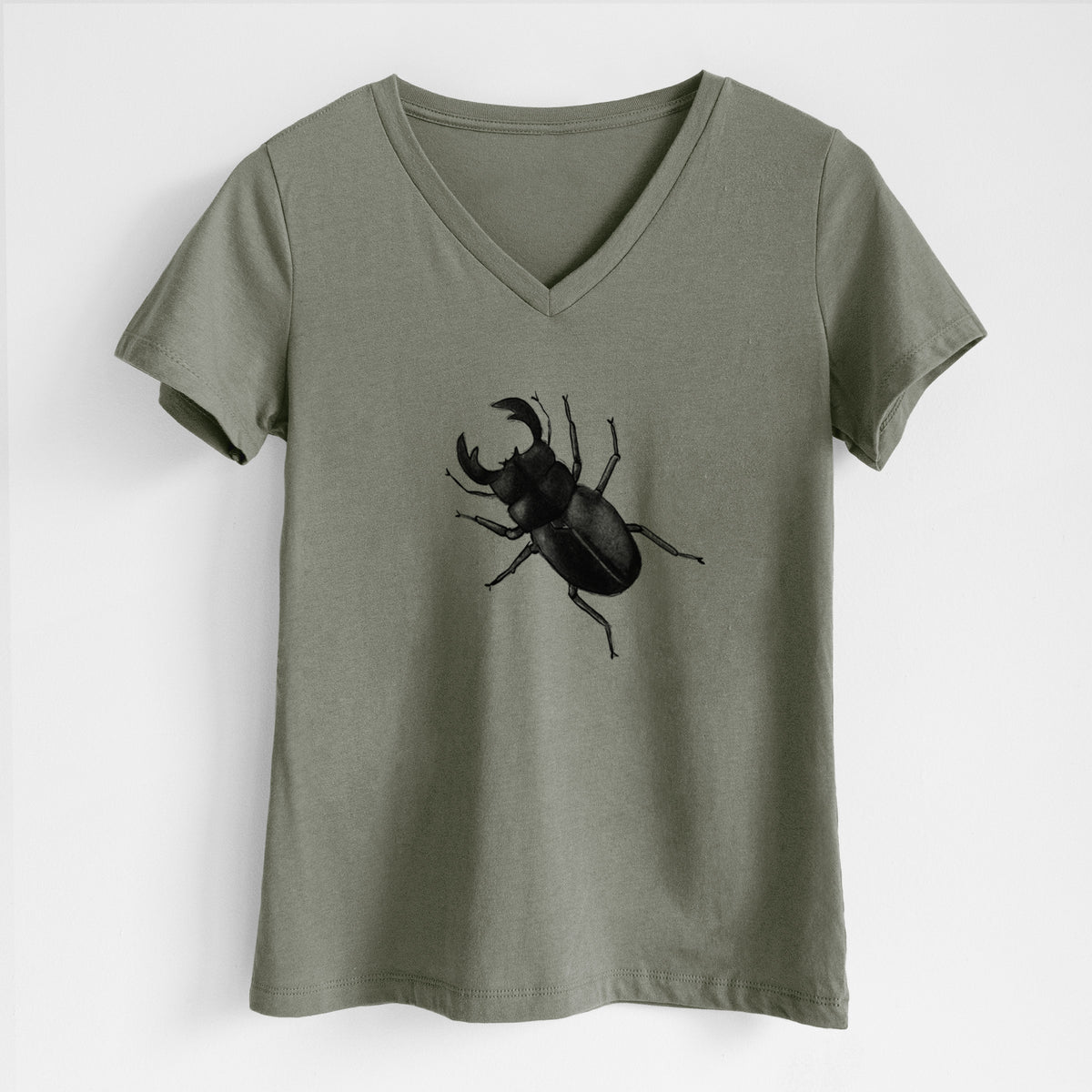 Military green women's relaxed fit cotton V-neck t-shirt laid flat, printed with a detailed black ink illustration of a giant stag beetle with large jaws, seen from above.