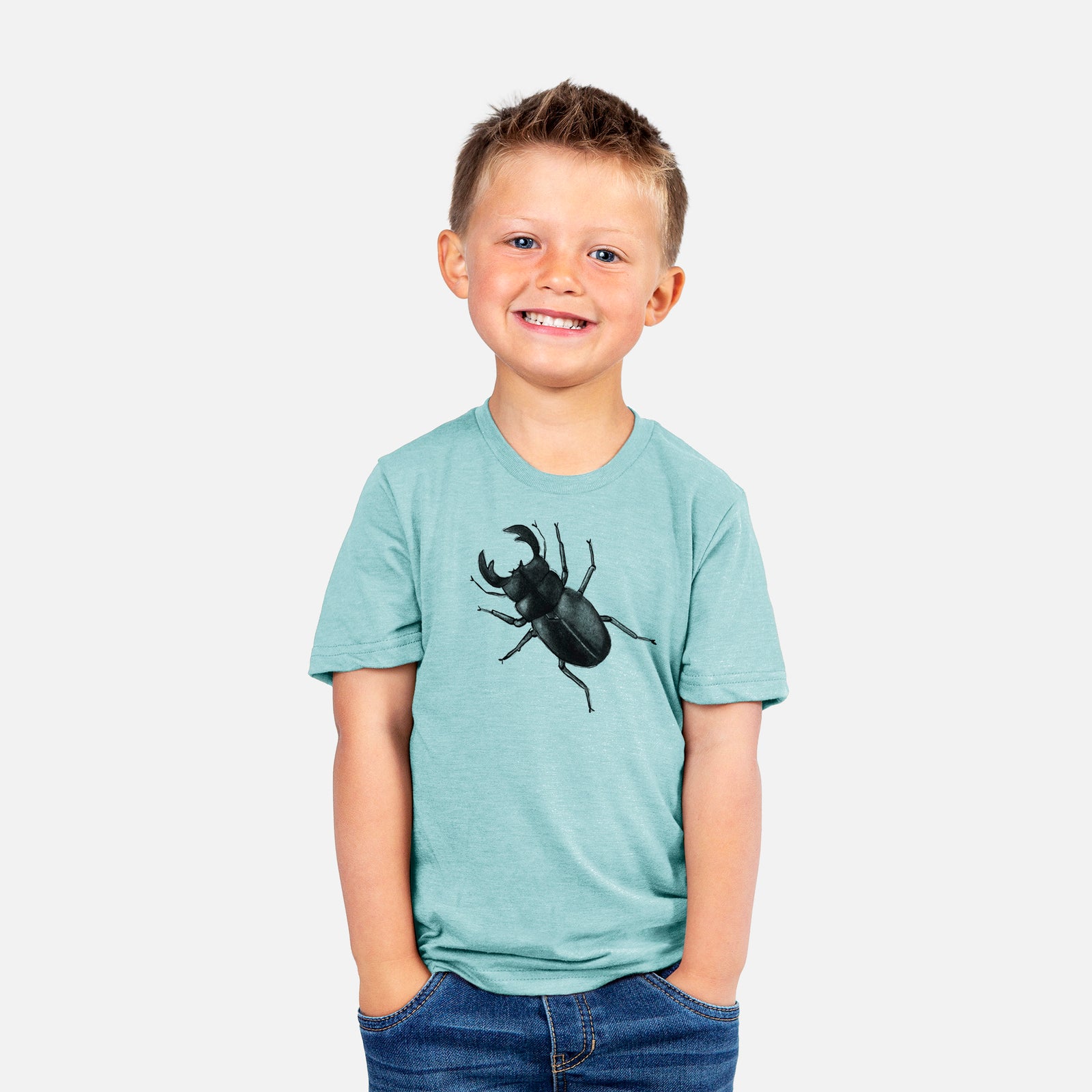Two youth t-shirts in different colors on hangers, printed with a detailed black ink illustration of a giant stag beetle with large jaws, seen from above.