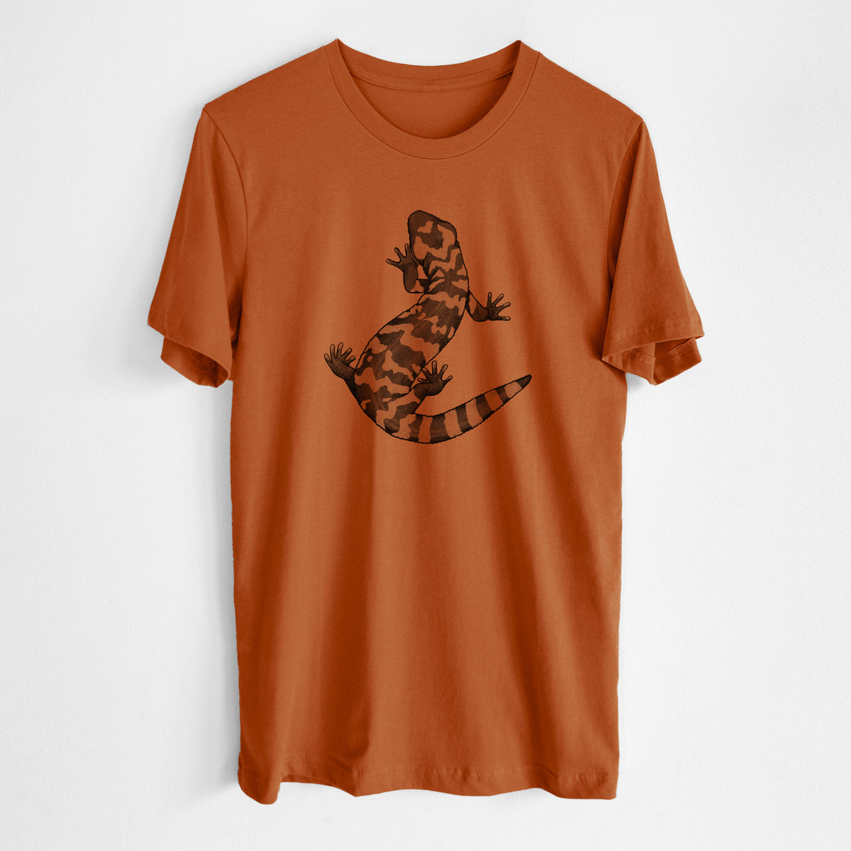 Autumn lightweight cotton t-shirt laid flat, printed with a black ink illustration of a Gila monster with bold patterned skin.