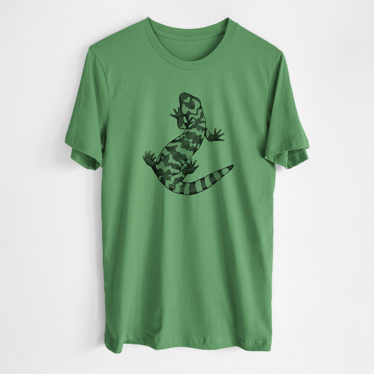 Leaf green lightweight cotton t-shirt laid flat, printed with a black ink illustration of a Gila monster with bold patterned skin.