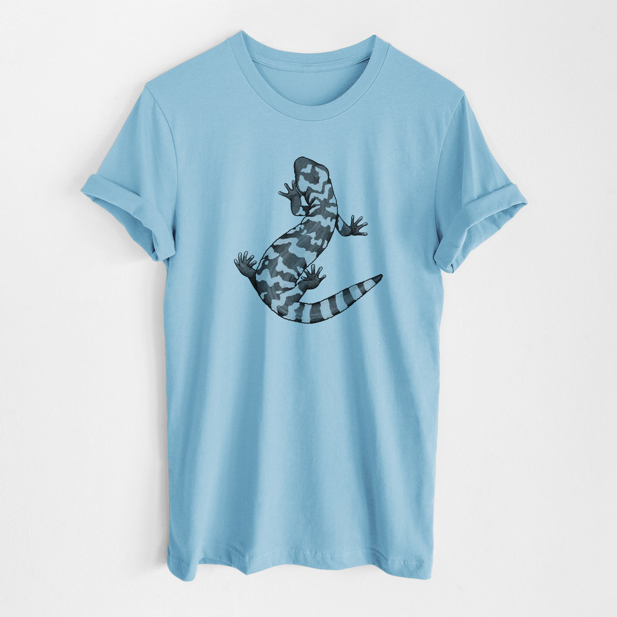 Ocean blue lightweight cotton t-shirt laid flat, printed with a black ink illustration of a Gila monster with bold patterned skin.