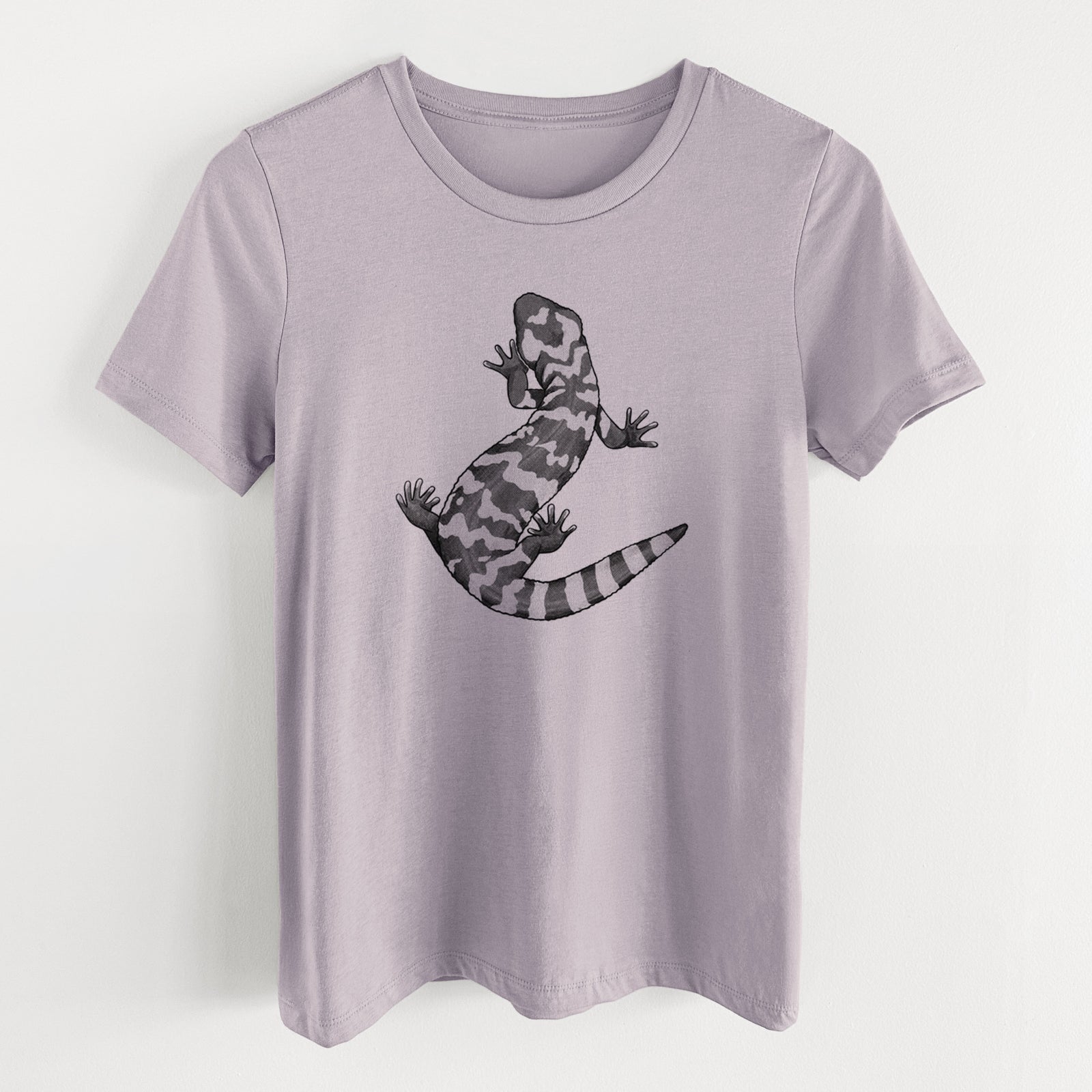 Light violet women's relaxed fit cotton t-shirt laid flat, printed with a black ink illustration of a Gila monster with bold patterned skin.
