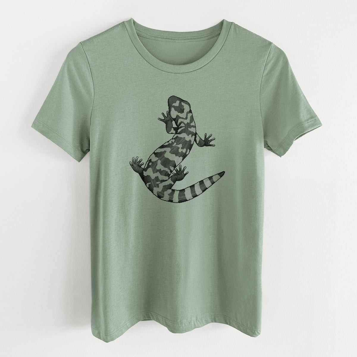 Sage green women's relaxed fit cotton t-shirt laid flat, printed with a black ink illustration of a Gila monster with bold patterned skin.