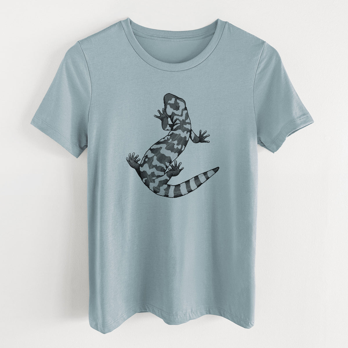 Vintage denim women's relaxed fit cotton t-shirt laid flat, printed with a black ink illustration of a Gila monster with bold patterned skin.