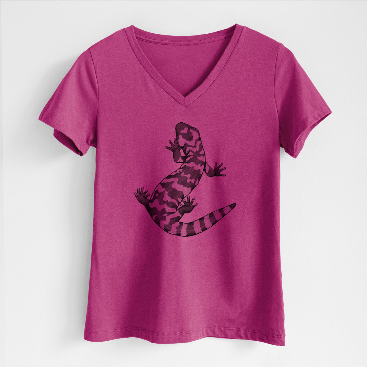 Berry pink women's relaxed fit cotton V-neck t-shirt laid flat, printed with a black ink illustration of a Gila monster with bold patterned skin.