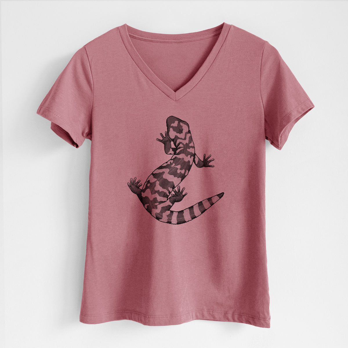 Mauve pink women's relaxed fit cotton V-neck t-shirt laid flat, printed with a black ink illustration of a Gila monster with bold patterned skin.