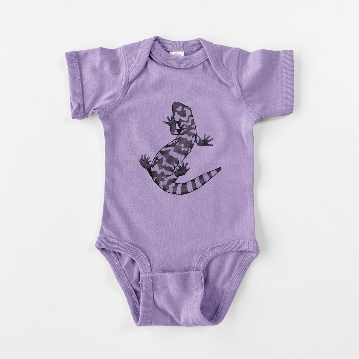 Lavender baby bodysuit laid flat, printed with a black ink illustration of a Gila monster with bold patterned skin.