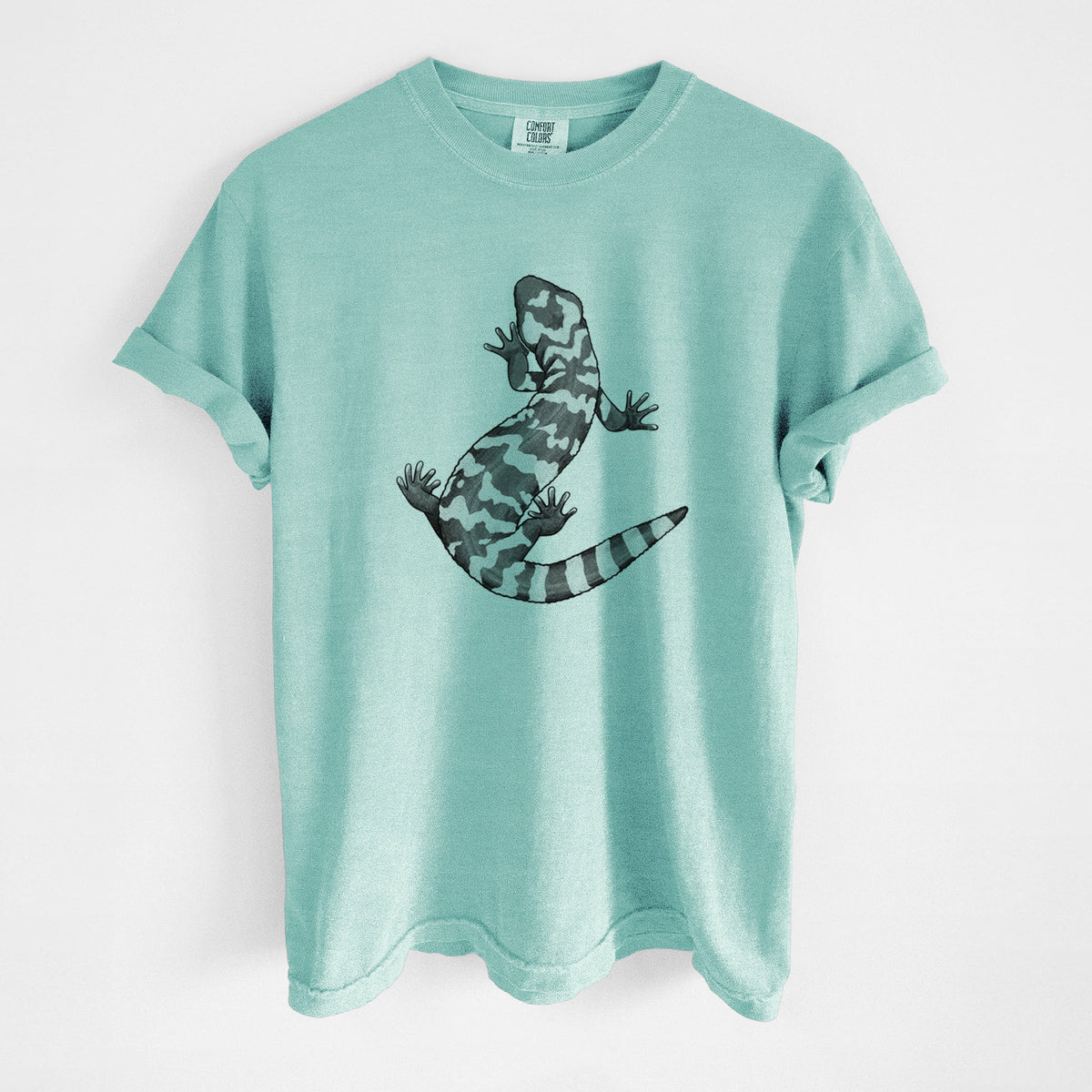 Chalky mint Comfort Colors t-shirt laid flat, printed with a black ink illustration of a Gila monster with bold patterned skin.