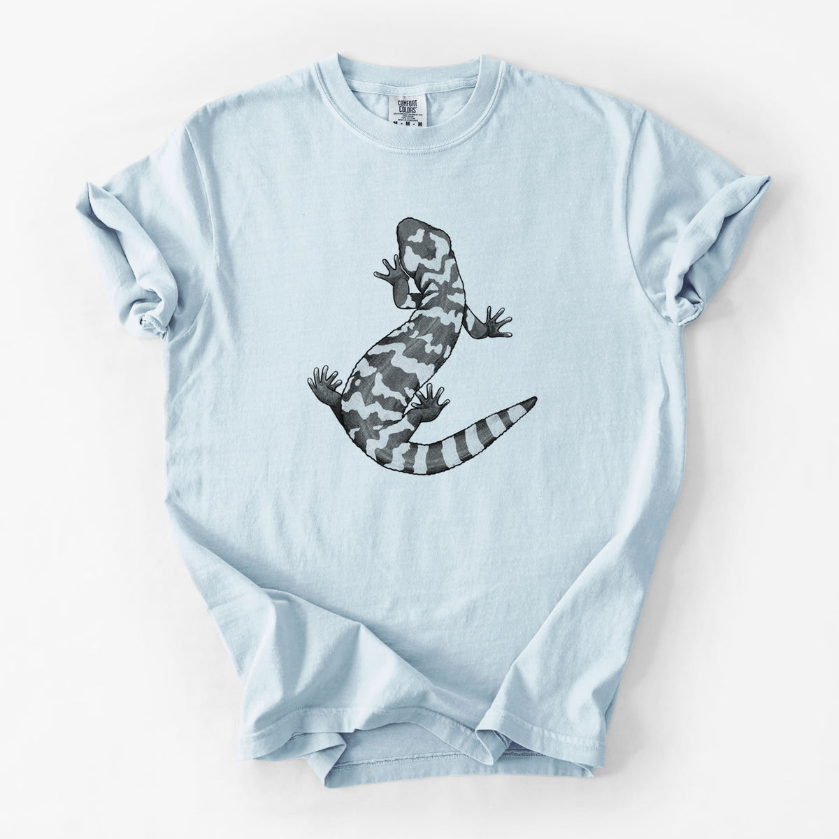 Chambray blue Comfort Colors t-shirt laid flat, printed with a black ink illustration of a Gila monster with bold patterned skin.