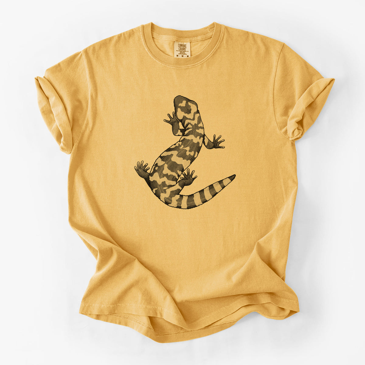 Golden wheat yellow Comfort Colors t-shirt laid flat, printed with a black ink illustration of a Gila monster with bold patterned skin.
