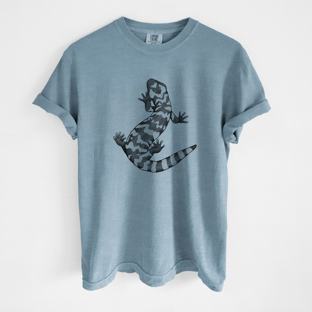 Steel blue Comfort Colors t-shirt laid flat, printed with a black ink illustration of a Gila monster with bold patterned skin.