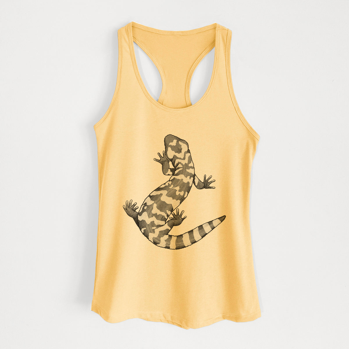 Banana cream women's racerback tank top laid flat, printed with a black ink illustration of a Gila monster with bold patterned skin.