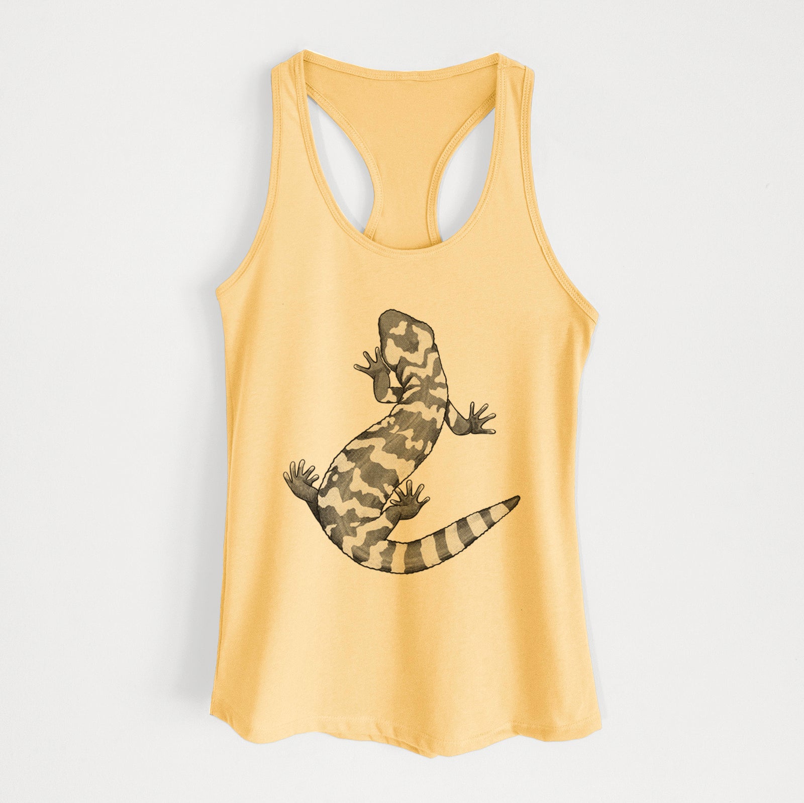 Banana cream women's racerback tank top laid flat, printed with a black ink illustration of a Gila monster with bold patterned skin.