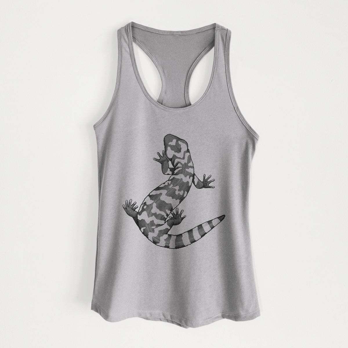 Heather grey women's racerback tank top laid flat, printed with a black ink illustration of a Gila monster with bold patterned skin.