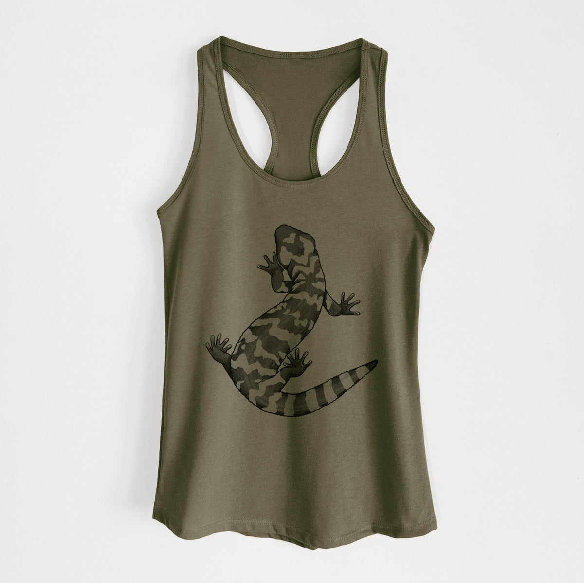 Military green women's racerback tank top laid flat, printed with a black ink illustration of a Gila monster with bold patterned skin.