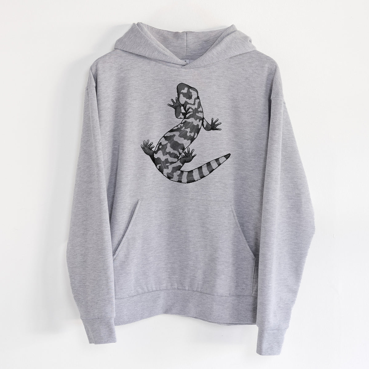 Gila Monster - Heloderma suspectum - Statement Midweight Hoodie in Heather Grey, hanging on a white wall, with a front kangaroo pocket and no drawcords.