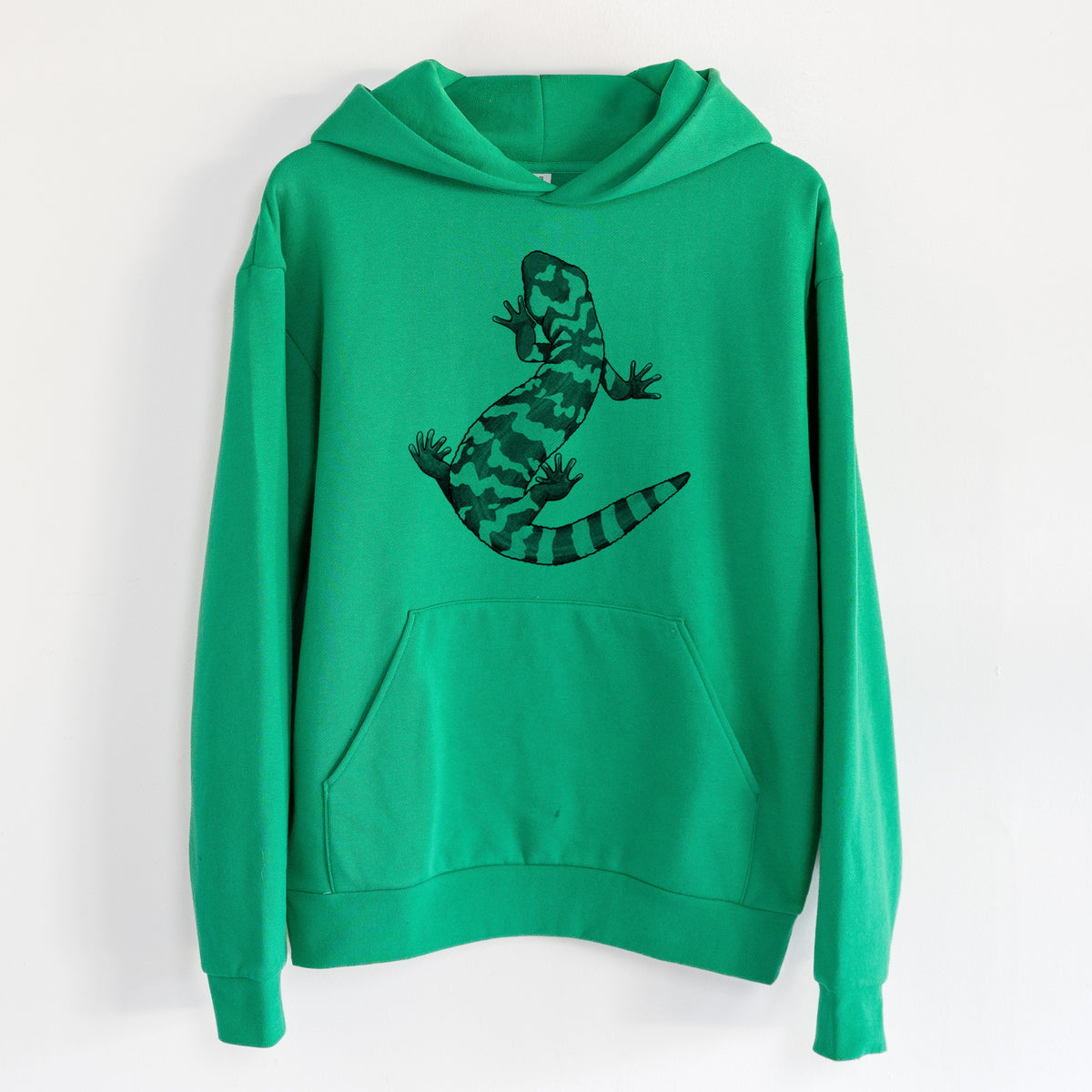 Gila Monster - Heloderma suspectum - Statement Midweight Hoodie in Kelly Green, hanging on a white wall, with a front kangaroo pocket and no drawcords.
