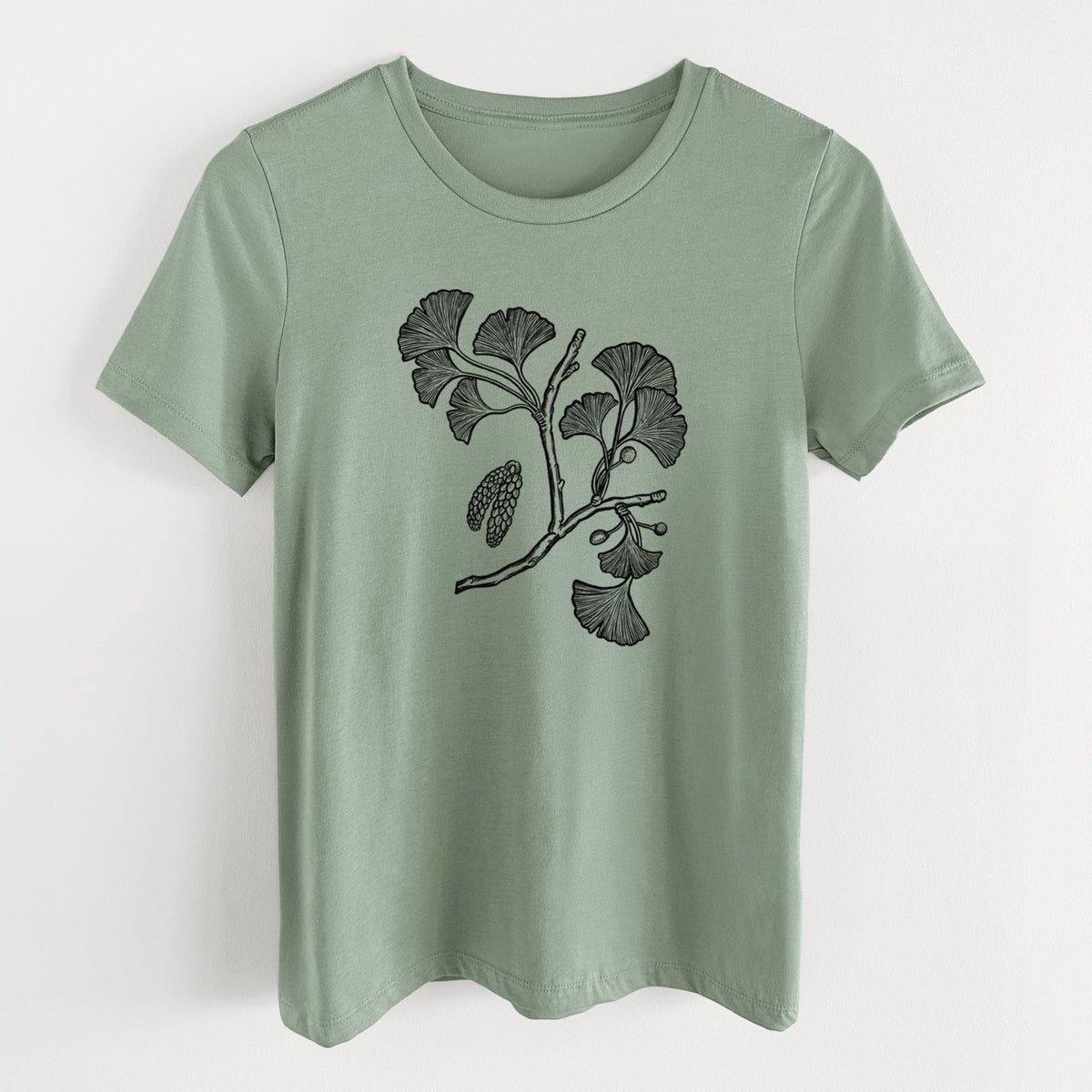 Sage green women's relaxed fit cotton t-shirt laid flat, printed with a black ink illustration of a ginkgo branch with fan-shaped leaves.