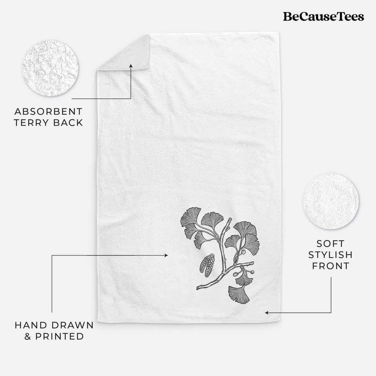 White hand towel printed with a black ink illustration of a ginkgo branch with fan-shaped leaves.