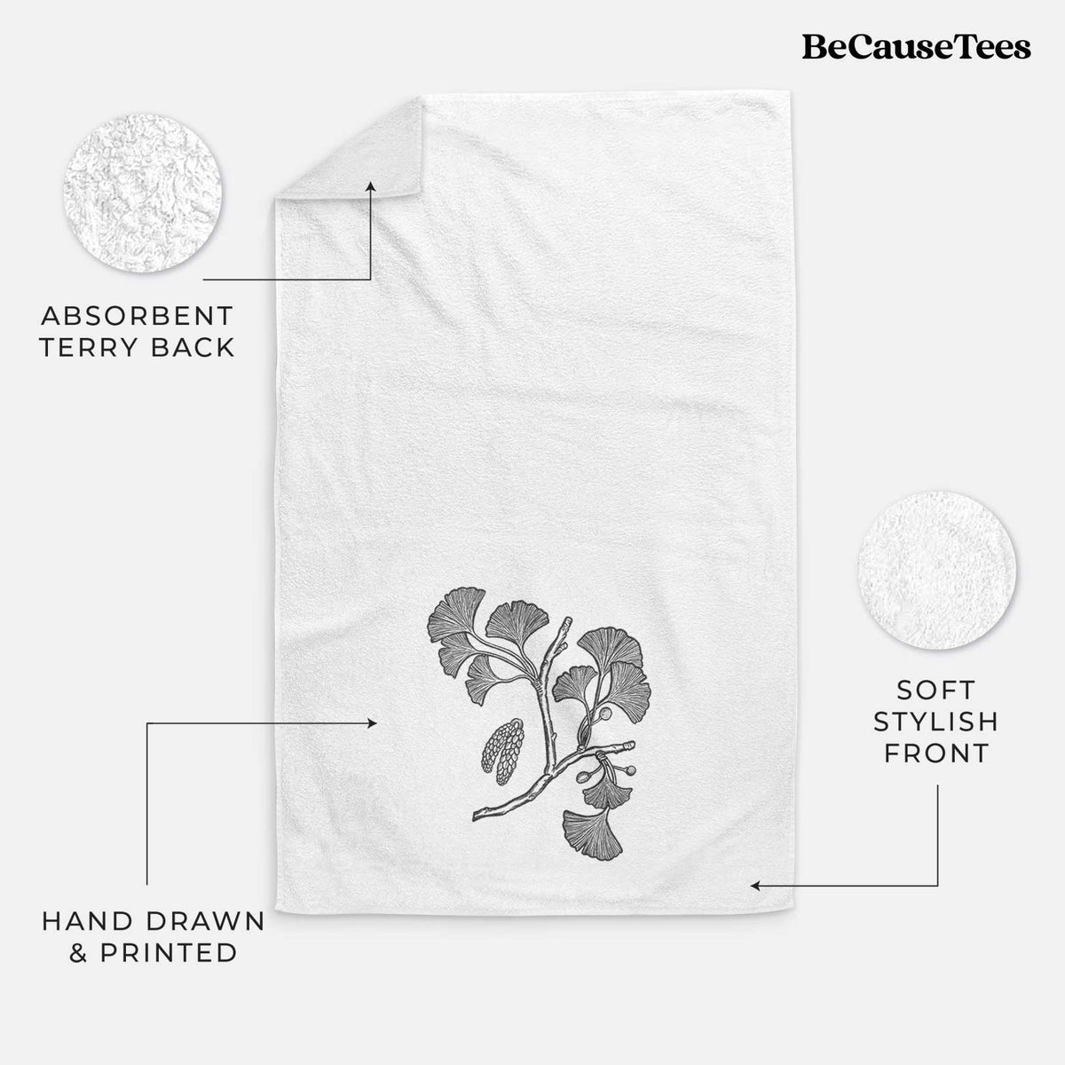 White hand towel printed with a black ink illustration of a ginkgo branch with fan-shaped leaves.