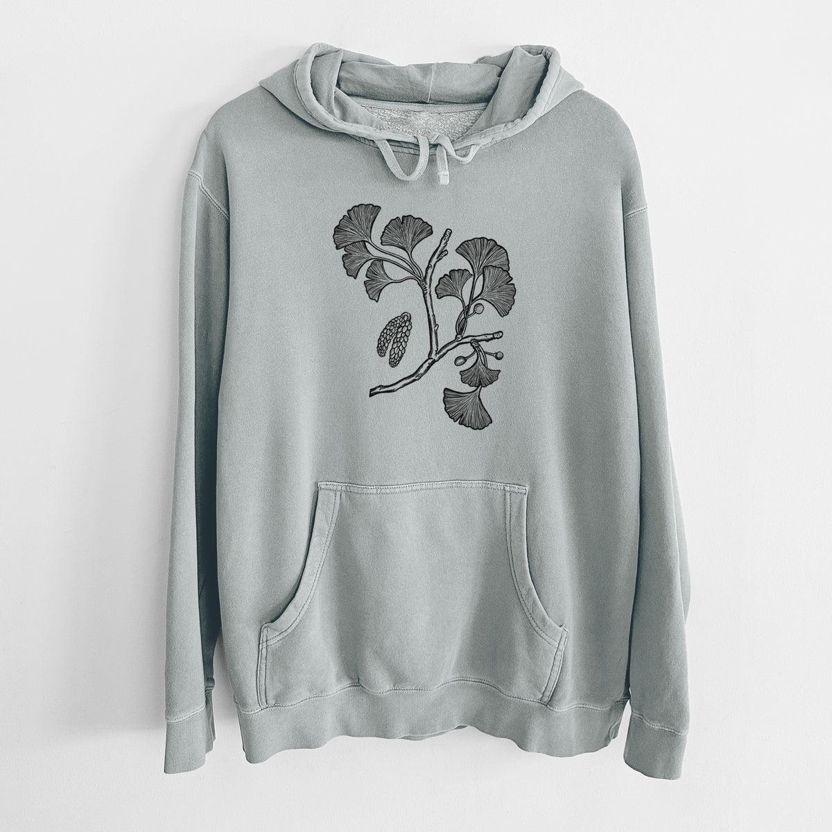 Sage green pigment dyed hoodie laid flat, printed with a black ink illustration of a ginkgo branch with fan-shaped leaves.