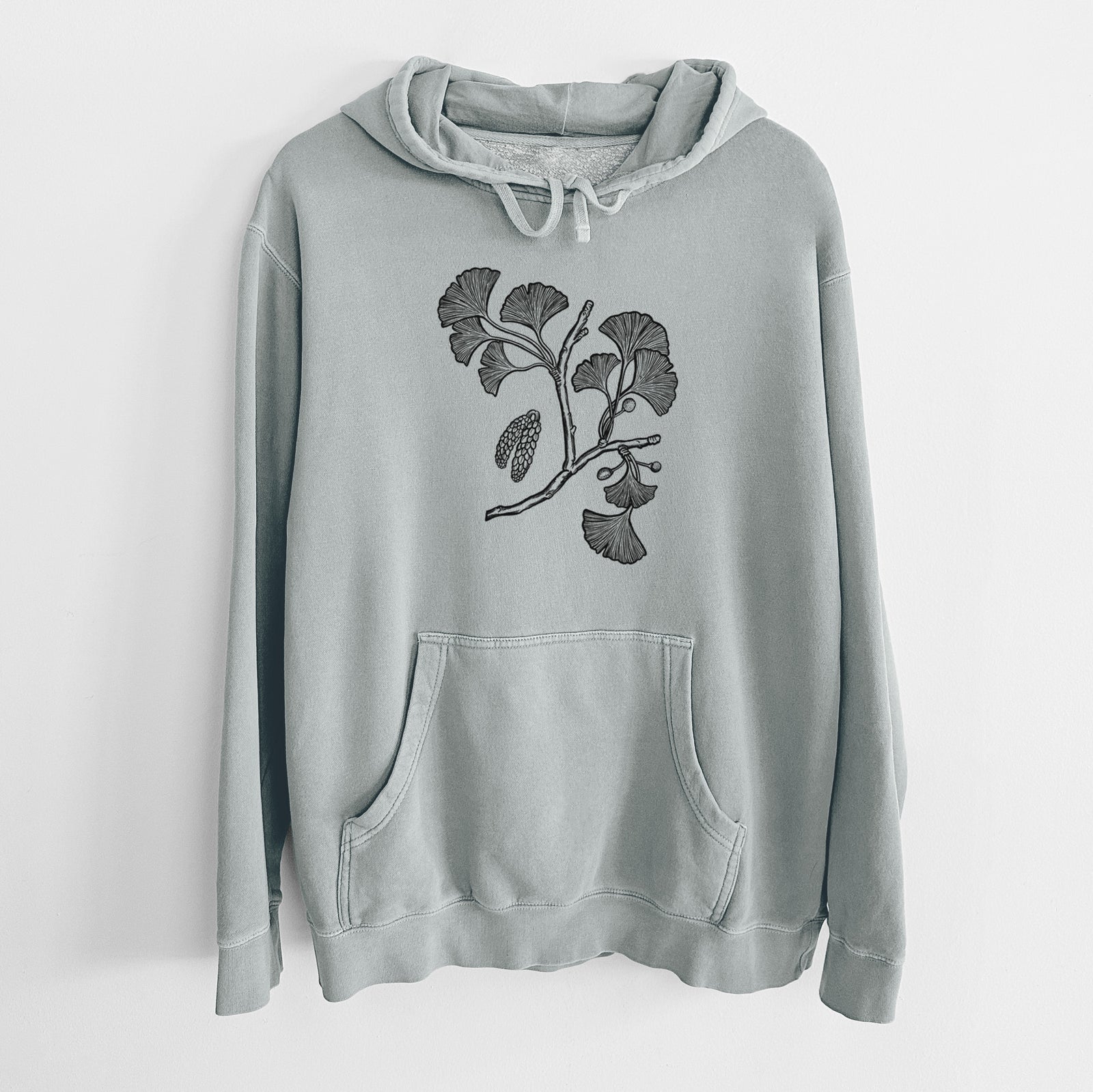 Sage green pigment dyed hoodie laid flat, printed with a black ink illustration of a ginkgo branch with fan-shaped leaves.