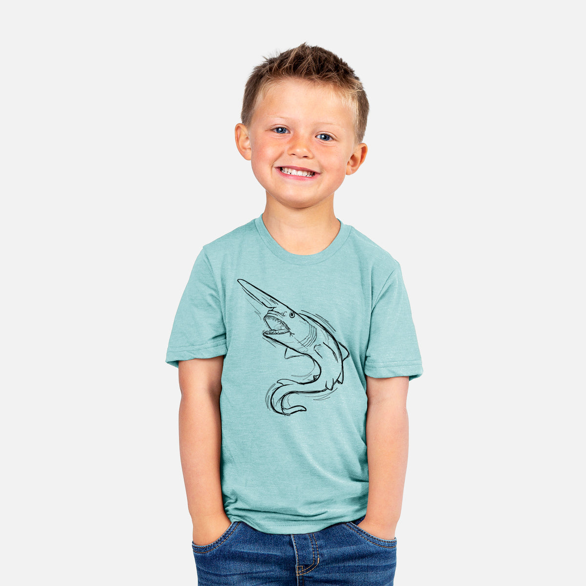 Smiling boy wearing a youth t-shirt printed with a black ink illustration of a goblin shark with its long snout, swimming in a curve.