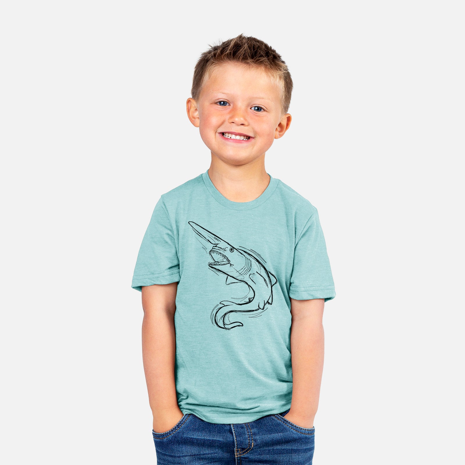 Two youth t-shirts in different colors on hangers, printed with a black ink illustration of a goblin shark with its long snout, swimming in a curve.