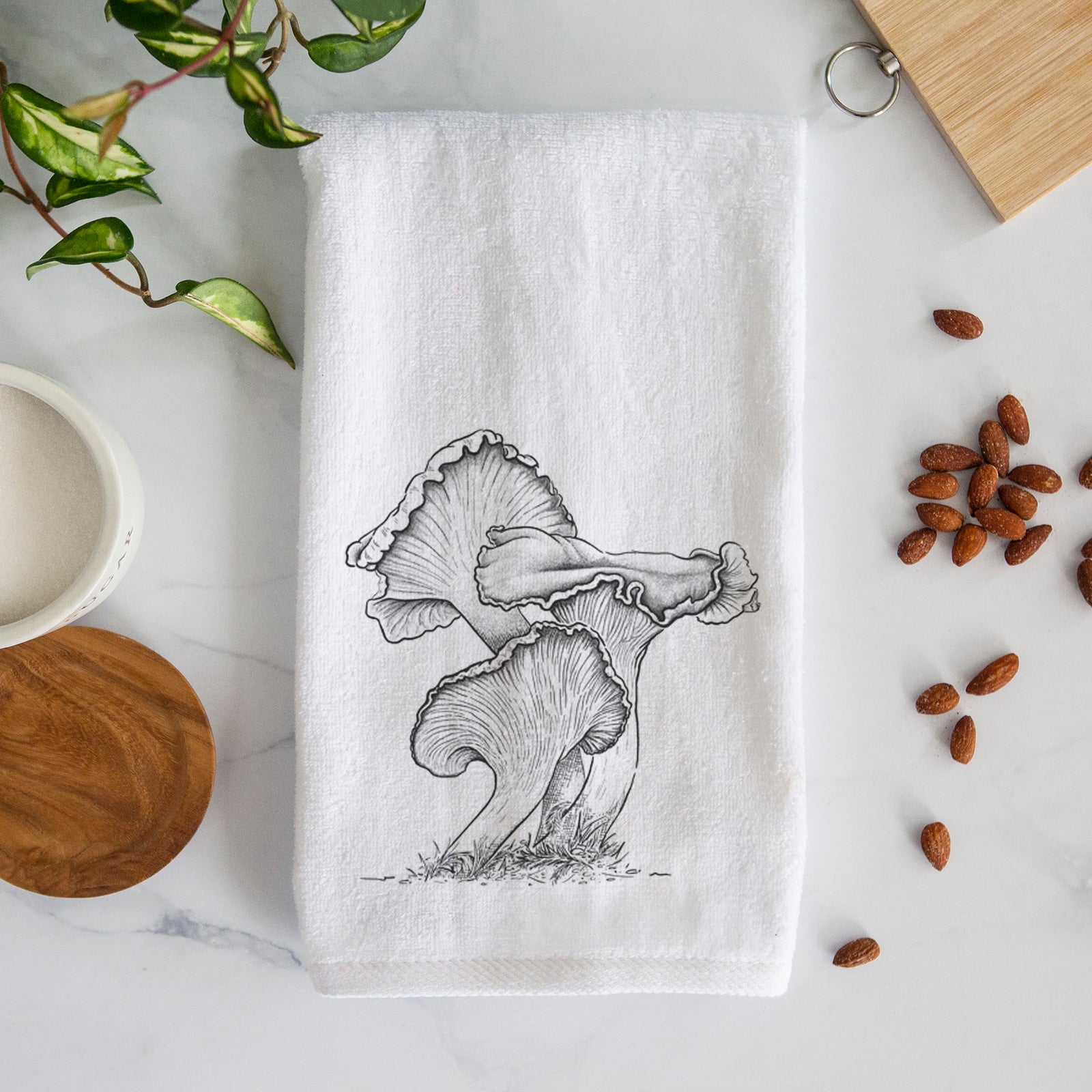 White hand towel printed with a detailed black ink illustration of golden chanterelle mushrooms.