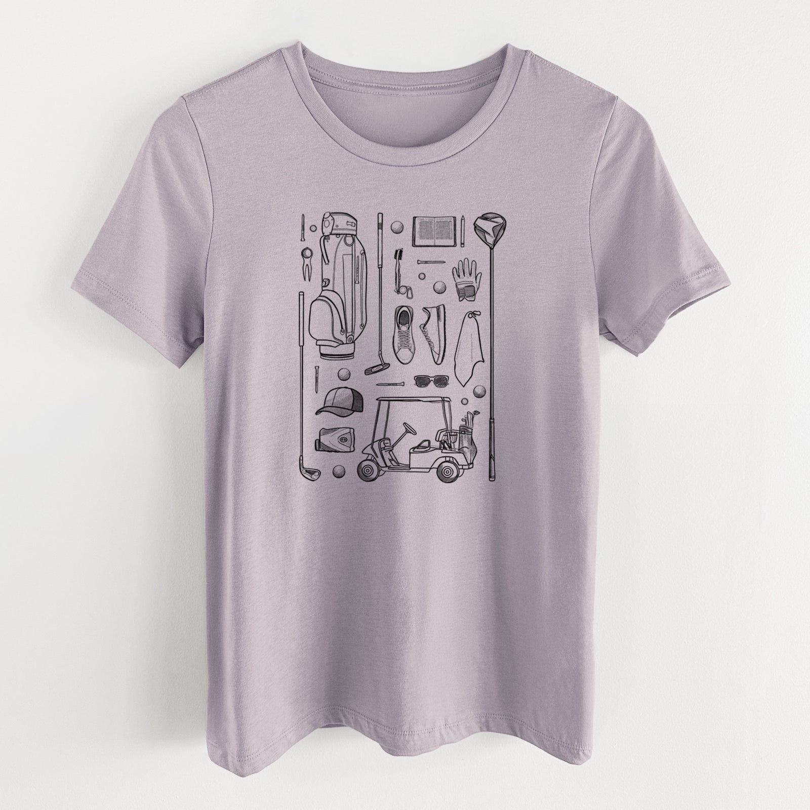 Light violet women's relaxed fit cotton t-shirt laid flat, printed with a black ink flat lay of golf gear, including a bag, clubs, balls, a cap, gloves and a cart.