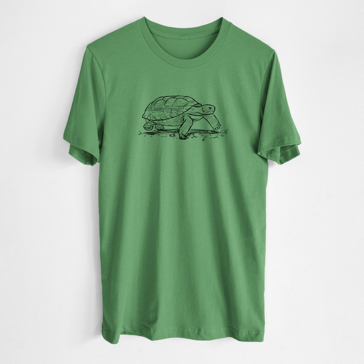 Leaf green lightweight cotton t-shirt laid flat, printed with a detailed black ink illustration of a gopher tortoise walking.