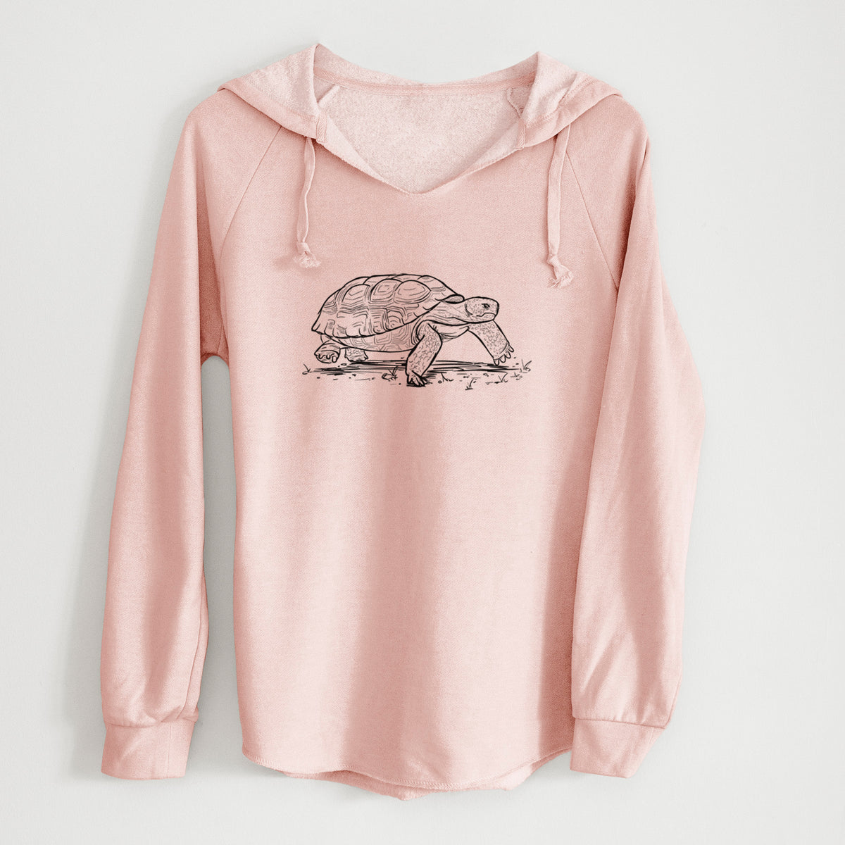 Blush pink women's Cali Wave hooded sweatshirt laid flat, printed with a detailed black ink illustration of a gopher tortoise walking.
