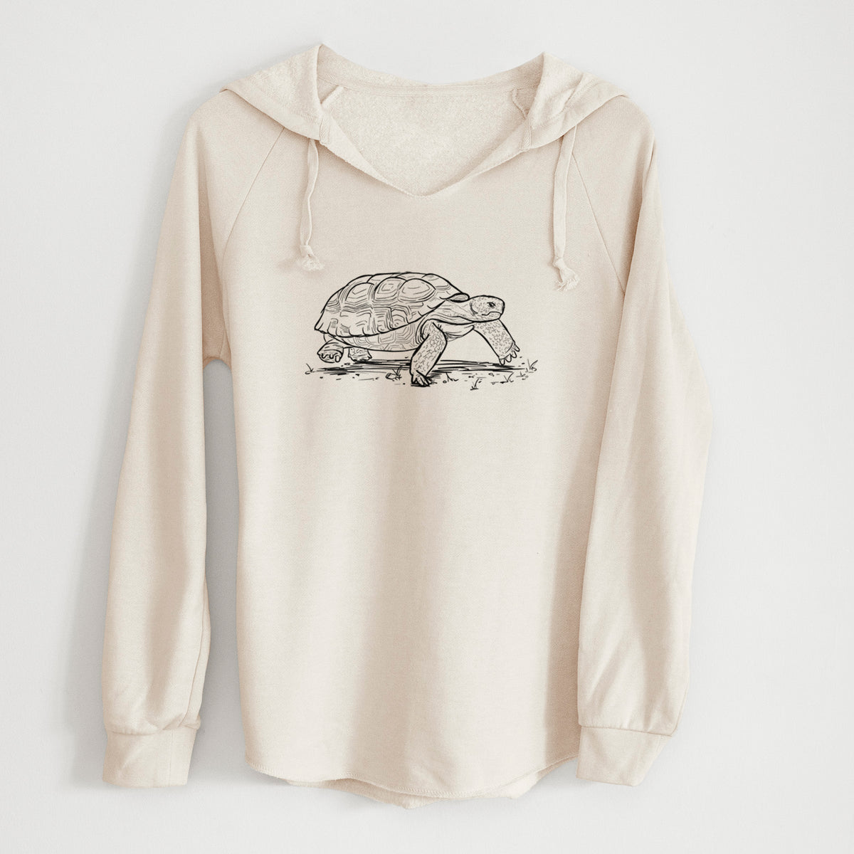 Bone cream women's Cali Wave hooded sweatshirt laid flat, printed with a detailed black ink illustration of a gopher tortoise walking.