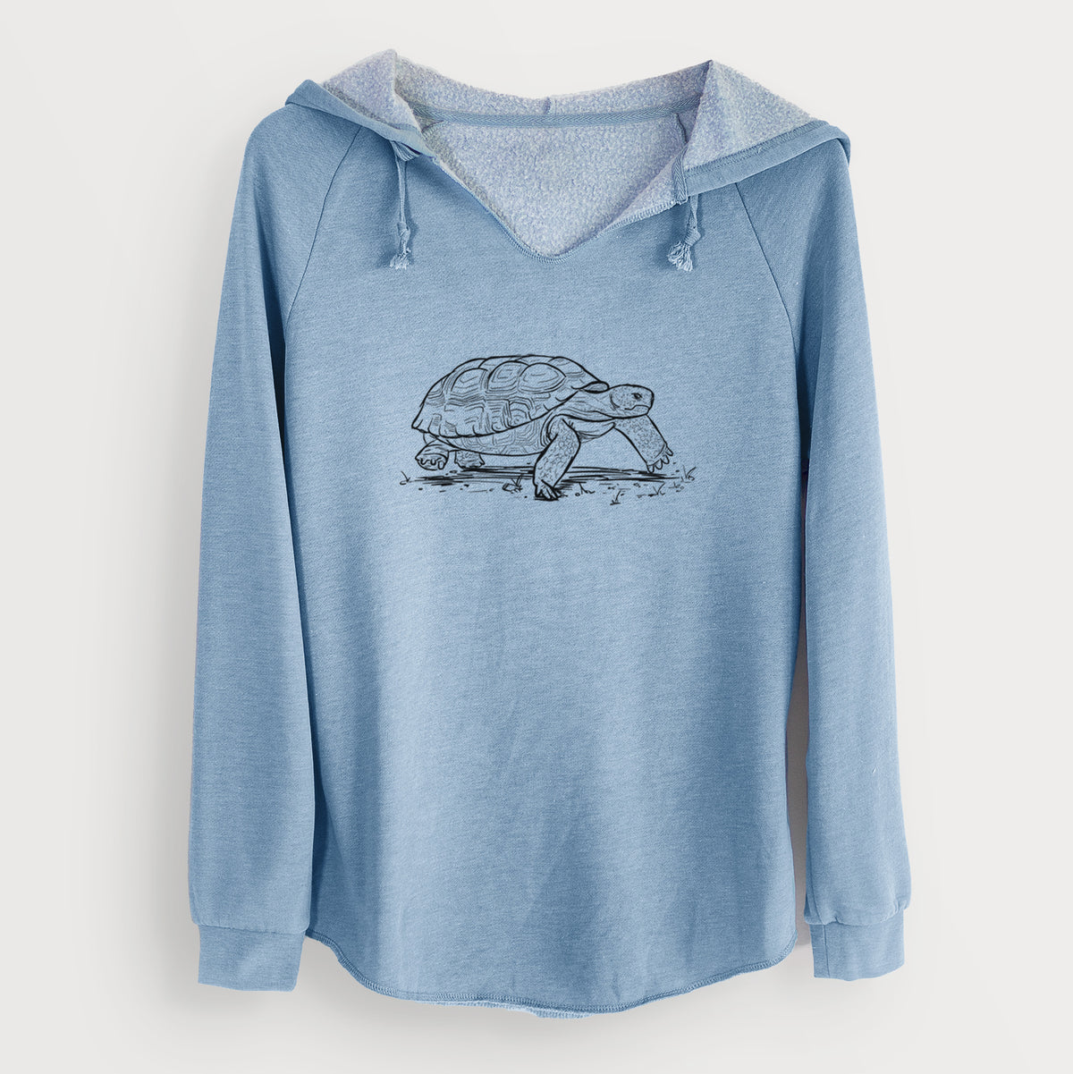 Misty blue women's Cali Wave hooded sweatshirt laid flat, printed with a detailed black ink illustration of a gopher tortoise walking.