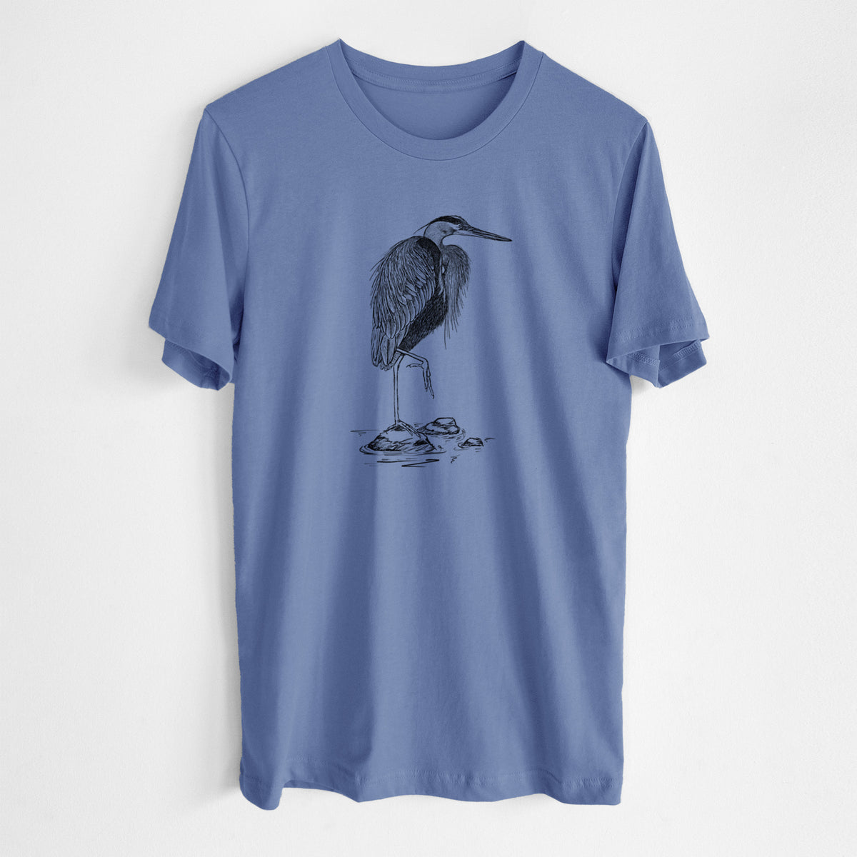 Blue bell lightweight cotton t-shirt laid flat, printed with a detailed black ink illustration of a great blue heron standing on rocks.