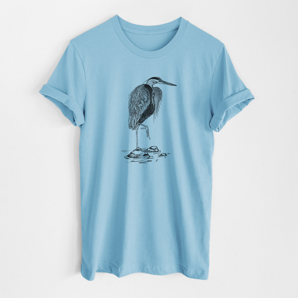 Ocean blue lightweight cotton t-shirt laid flat, printed with a detailed black ink illustration of a great blue heron standing on rocks.
