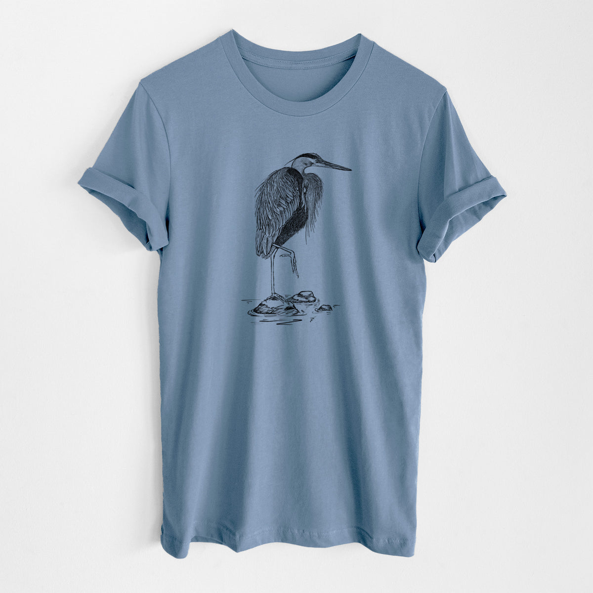 Steel blue lightweight cotton t-shirt laid flat, printed with a detailed black ink illustration of a great blue heron standing on rocks.