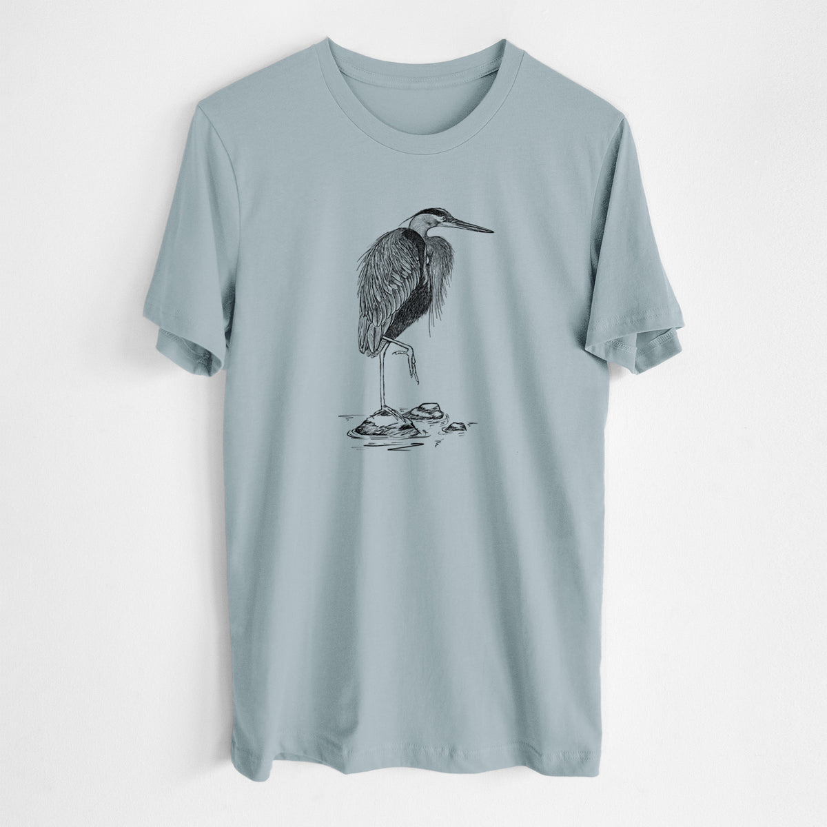 Vintage denim lightweight cotton t-shirt laid flat, printed with a detailed black ink illustration of a great blue heron standing on rocks.