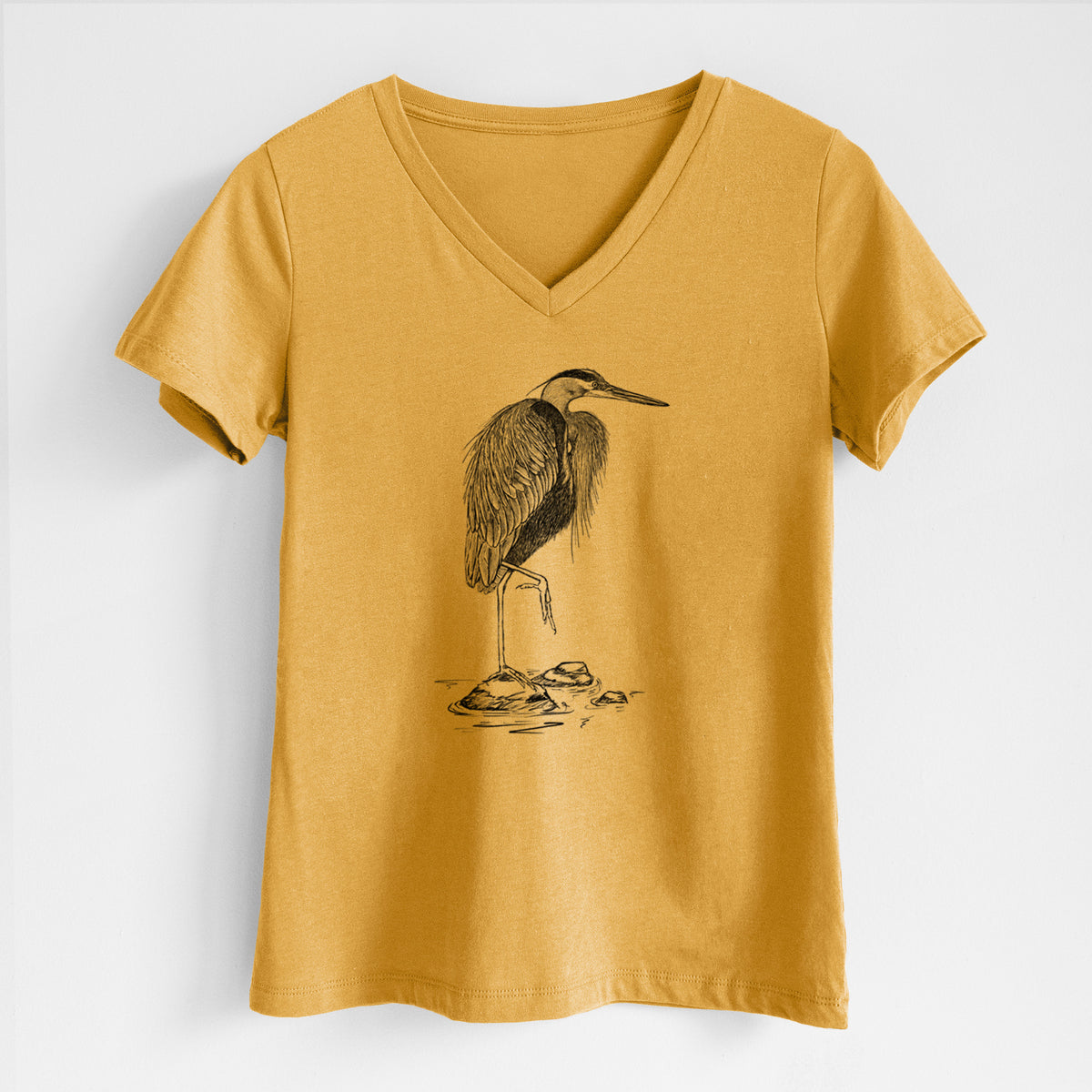 Honeycomb yellow women's relaxed fit cotton V-neck t-shirt laid flat, printed with a detailed black ink illustration of a great blue heron standing on rocks.