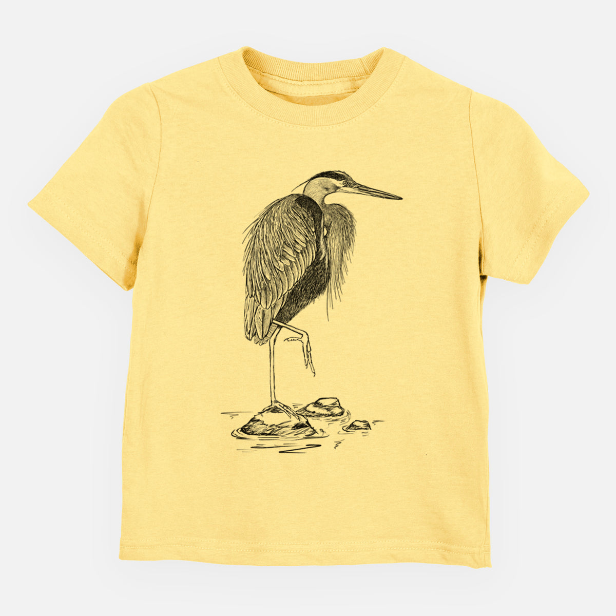 Butter yellow toddler t-shirt laid flat, printed with a detailed black ink illustration of a great blue heron standing on rocks.
