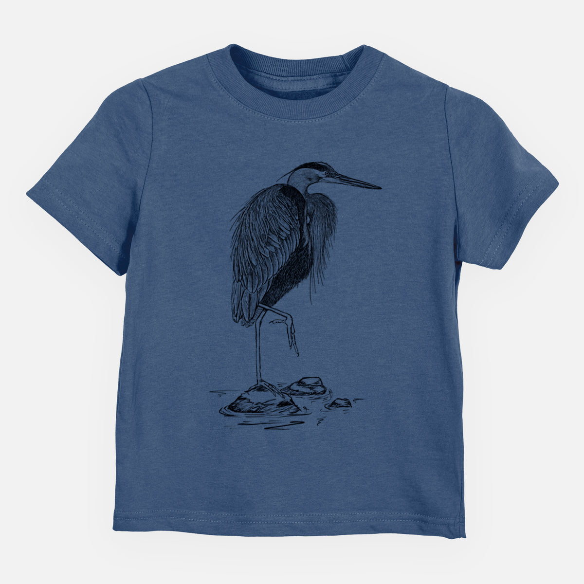 Indigo blue toddler t-shirt laid flat, printed with a detailed black ink illustration of a great blue heron standing on rocks.