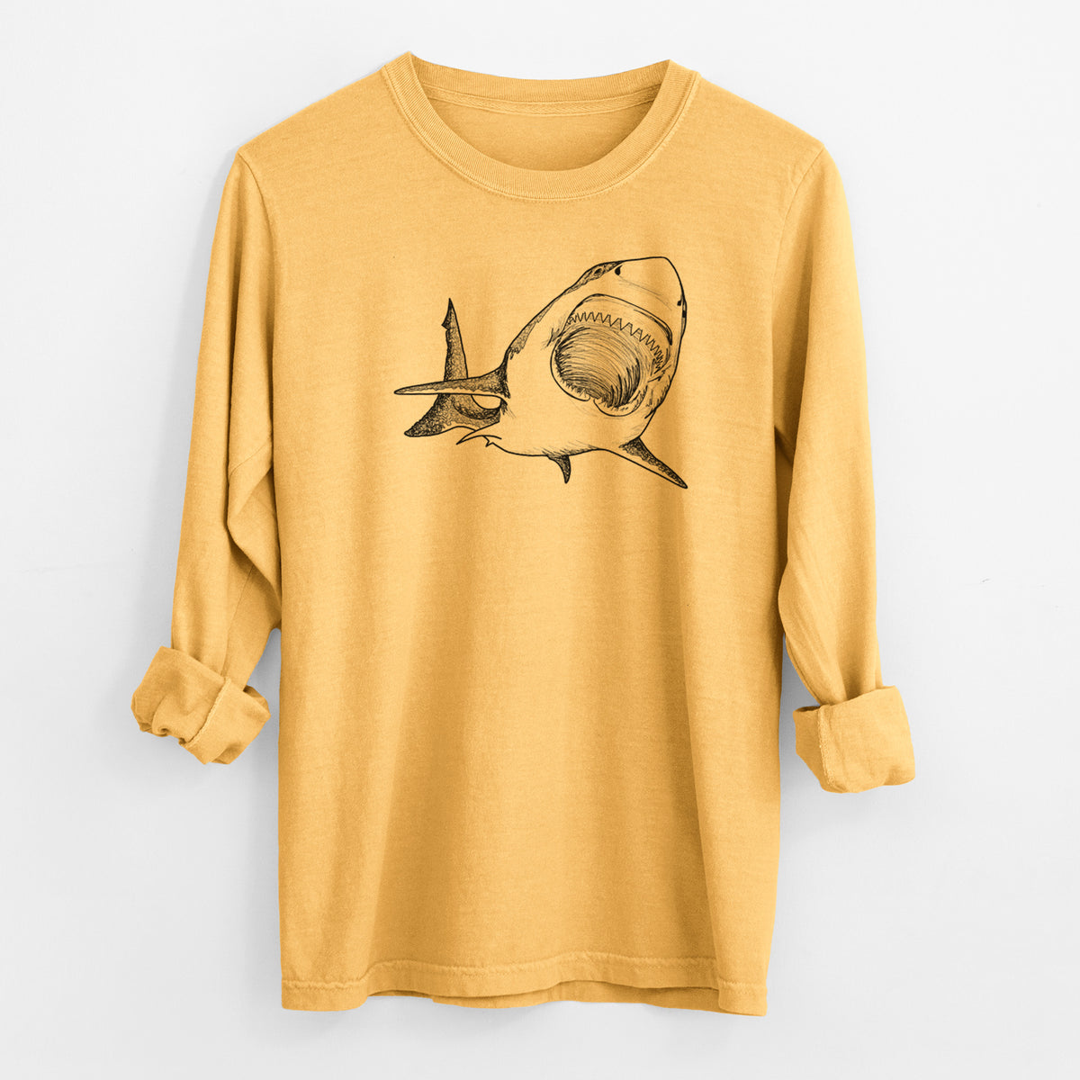 Golden wheat yellow Comfort Colors long sleeve shirt laid flat with the cuffs rolled, printed with a black ink illustration of a great white shark swimming toward the viewer with its mouth open.