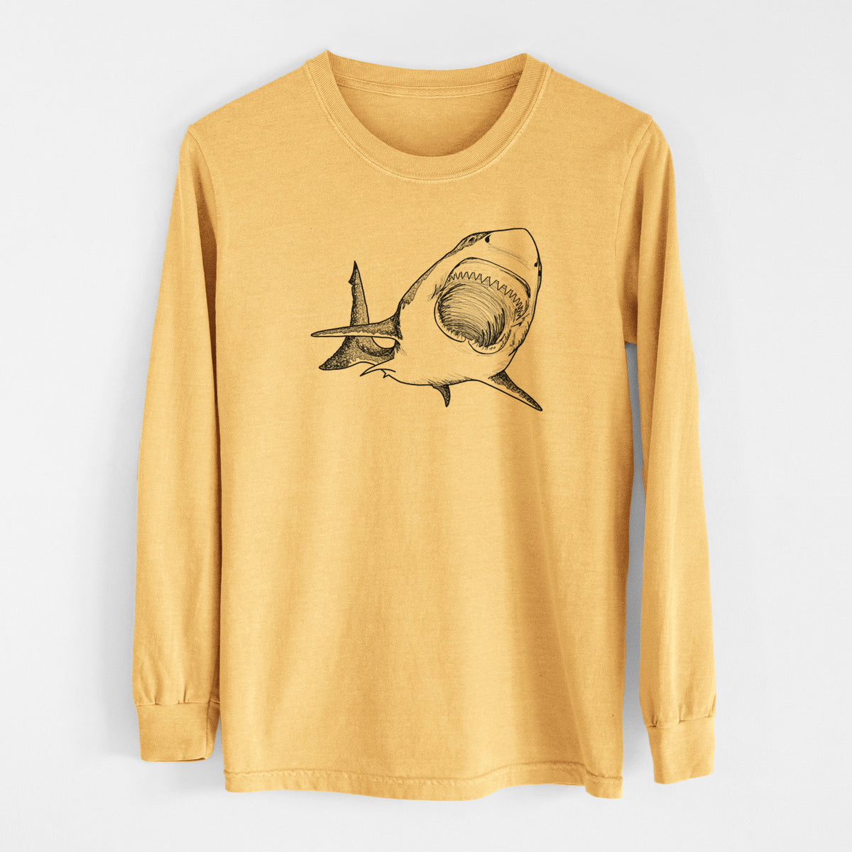 Golden wheat yellow Comfort Colors long sleeve shirt laid flat, printed with a black ink illustration of a great white shark swimming toward the viewer with its mouth open.