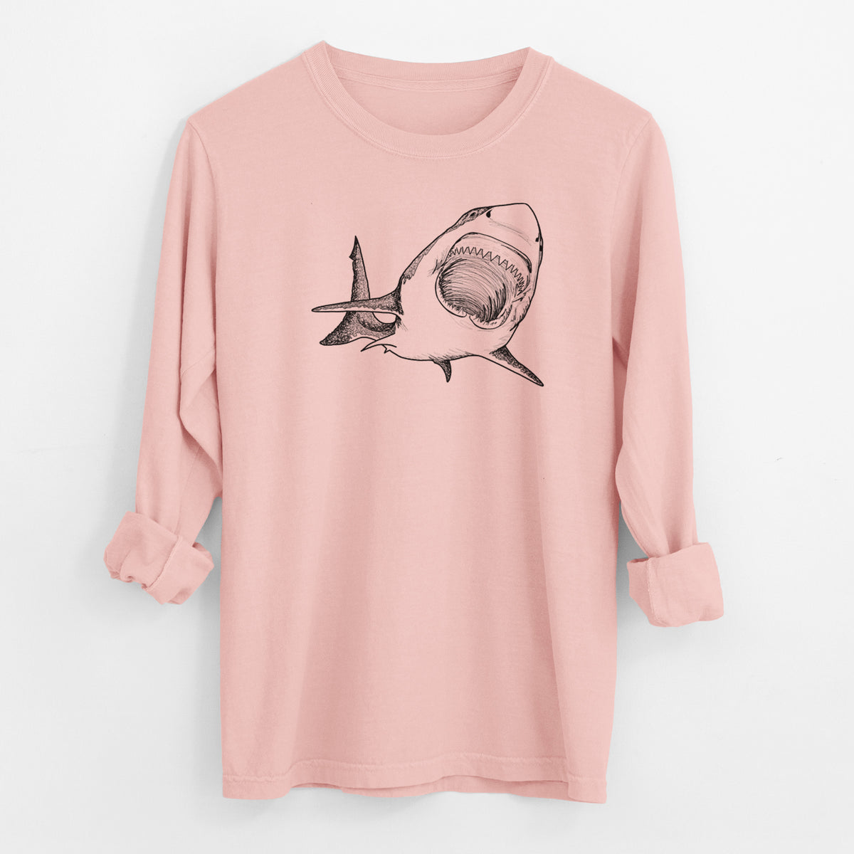 Peachy Comfort Colors long sleeve shirt laid flat with the cuffs rolled, printed with a black ink illustration of a great white shark swimming toward the viewer with its mouth open.