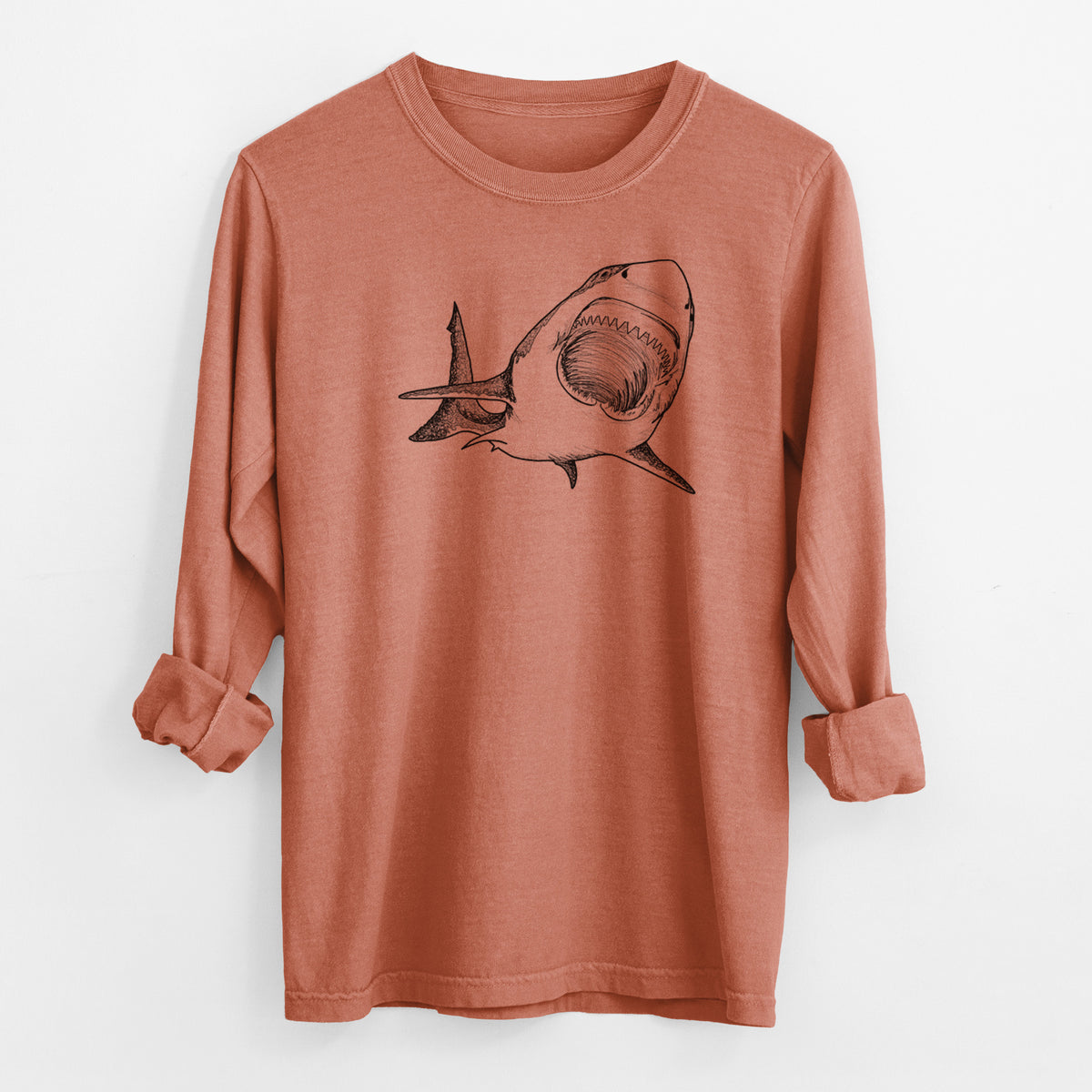 Yam burnt orange Comfort Colors long sleeve shirt laid flat with the cuffs rolled, printed with a black ink illustration of a great white shark swimming toward the viewer with its mouth open.