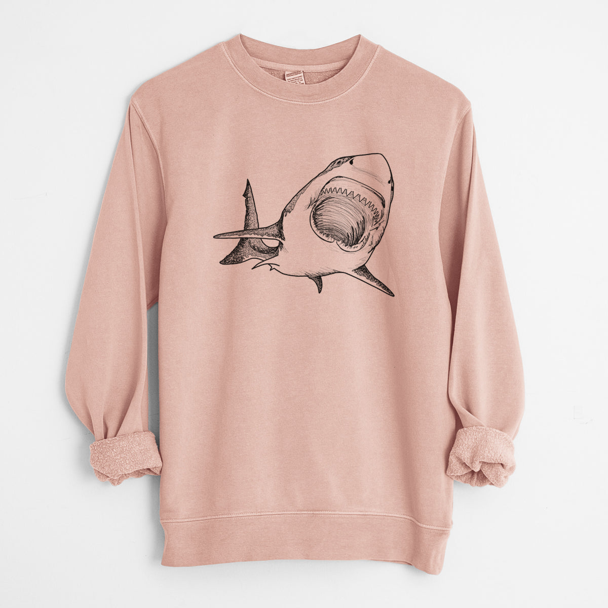 Dusty pink pigment dyed crewneck sweatshirt laid flat with the sleeves rolled, printed with a black ink illustration of a great white shark swimming toward the viewer with its mouth open.