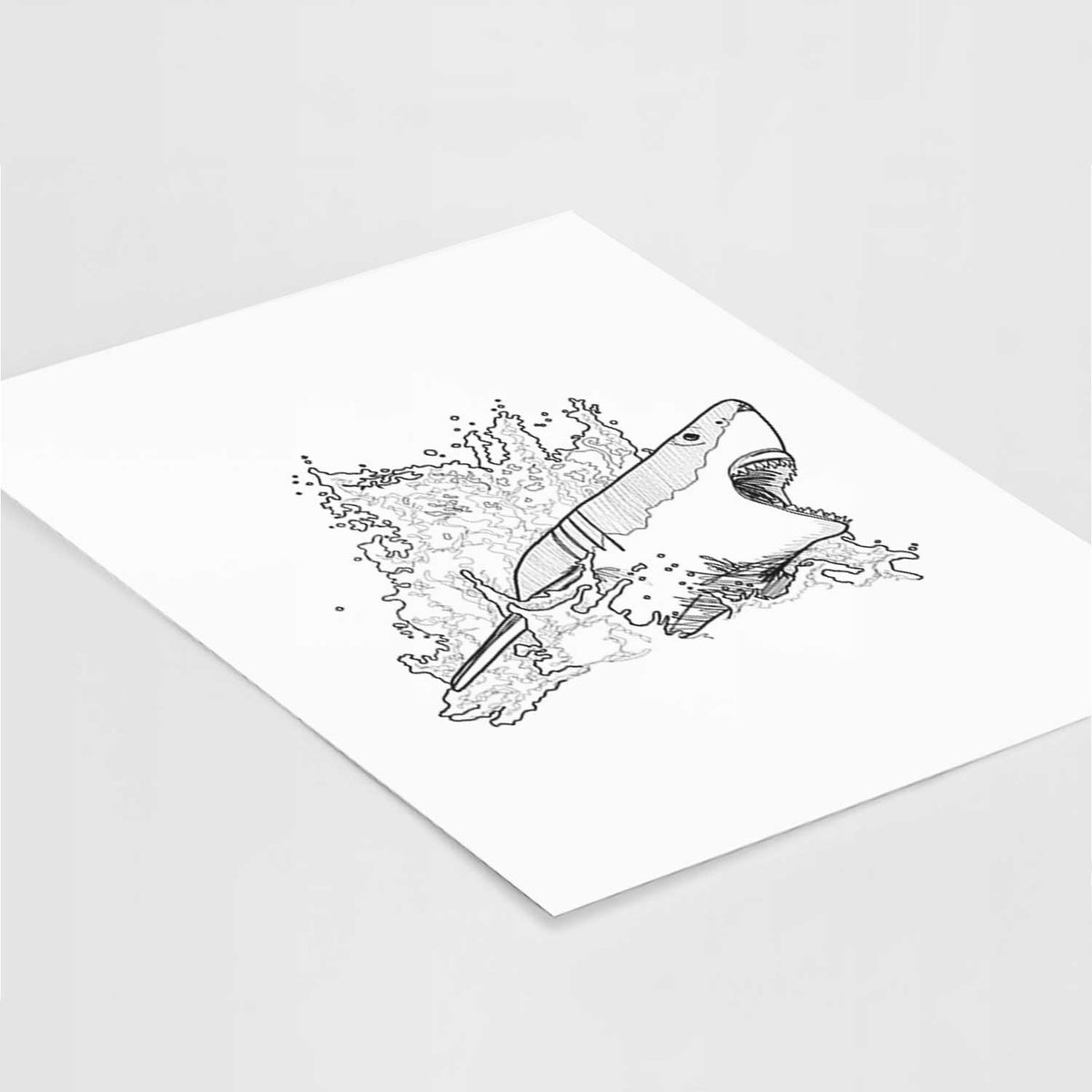 Art print of a black ink illustration of a great white shark breaking through a splash of water, lying at an angle on a white surface.