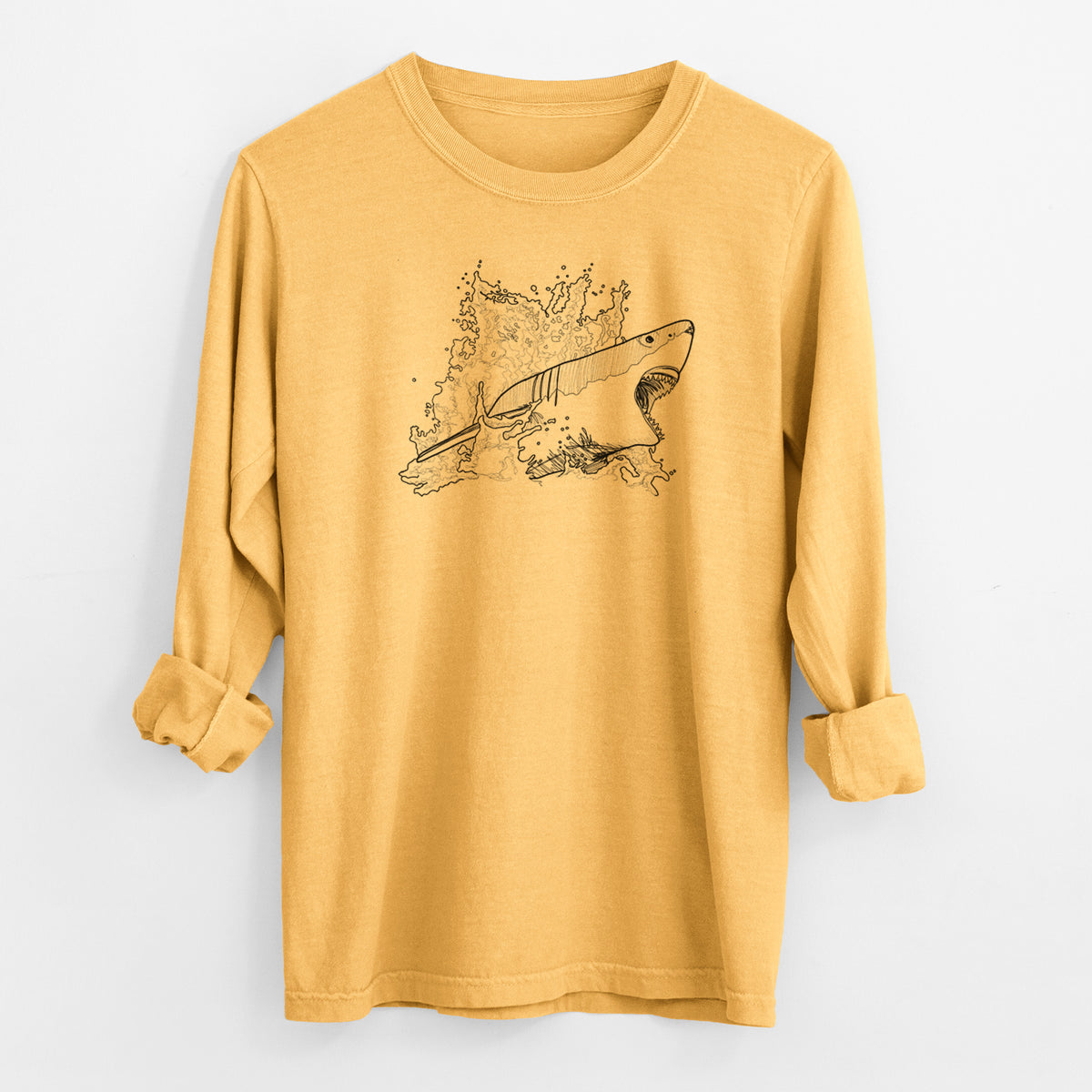 Golden wheat yellow Comfort Colors long sleeve shirt laid flat with the cuffs rolled, printed with a black ink illustration of a great white shark breaking through a splash of water.